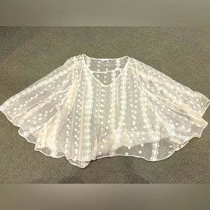 Sheer embroidered swing top. Cream.